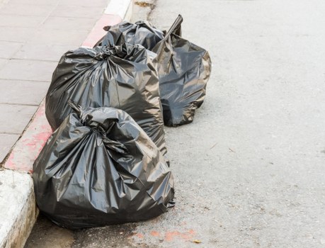 Segregated waste containers lined up in a yard