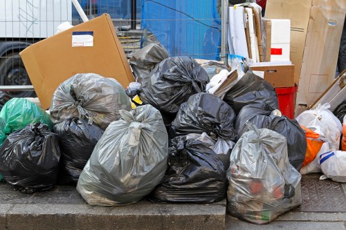 Commercial waste removal team loading a van at a shopfront
